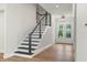 The home features a modern staircase and a bright entryway with double doors at 523 Sanctuary Golf Pl, Apopka, FL 32712