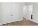 Hallway with neutral walls, hardwood floors, and plenty of storage space at 523 Sanctuary Golf Pl, Apopka, FL 32712