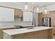 Stylish kitchen with a large island, pendant lights, stainless steel appliances, and white countertops at 523 Sanctuary Golf Pl, Apopka, FL 32712