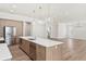 Bright and open kitchen with stainless steel appliances, an island sink, and views of the backyard and living area at 523 Sanctuary Golf Pl, Apopka, FL 32712