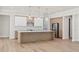 Modern kitchen featuring stainless steel appliances, a center island with pendant lighting, and light wood cabinets at 523 Sanctuary Golf Pl, Apopka, FL 32712