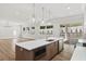 Open kitchen with stainless steel appliances, a large island, and access to the backyard patio through sliding glass doors at 523 Sanctuary Golf Pl, Apopka, FL 32712