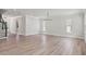 Spacious living room boasts beautiful floors, natural light, and modern chandelier at 523 Sanctuary Golf Pl, Apopka, FL 32712
