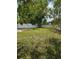 Fenced backyard offers a private outdoor space with mature trees and green grass at 5396 Lonesome Dove Dr, Kissimmee, FL 34746