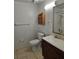 Neutral bathroom featuring tile flooring, wooden medicine cabinet, and standard fixtures at 5396 Lonesome Dove Dr, Kissimmee, FL 34746