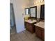 Bathroom featuring double vanity, tile floors and mirrors at 5396 Lonesome Dove Dr, Kissimmee, FL 34746