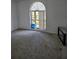 Cozy bedroom with carpeted floor and large arched window at 5396 Lonesome Dove Dr, Kissimmee, FL 34746