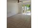 Spacious bedroom with tile flooring, sliding door and bright space at 5396 Lonesome Dove Dr, Kissimmee, FL 34746