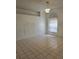 Bright living room with large window, modern chandelier, neutral paint, and tile flooring creating a versatile space at 5396 Lonesome Dove Dr, Kissimmee, FL 34746