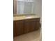 Bathroom featuring wood cabinets, a granite countertop and neutral wall color at 5725 Gatlin Ave # 315, Orlando, FL 32822