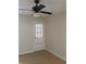 This bedroom features neutral walls, a ceiling fan, and a door with built in blinds at 5725 Gatlin Ave # 315, Orlando, FL 32822