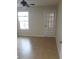 Bright bedroom with tile floors, a ceiling fan, and a door to the outside at 5725 Gatlin Ave # 315, Orlando, FL 32822