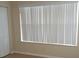 Bedroom showing closet door and window with white blinds and neutral walls at 5725 Gatlin Ave # 315, Orlando, FL 32822