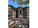 Two-story brown and white apartment building with a sidewalk leading to an entrance and trees overhead at 5725 Gatlin Ave # 315, Orlando, FL 32822