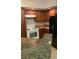 Kitchen with a white stove, dark cabinets, granite counters, and a black refrigerator at 5725 Gatlin Ave # 315, Orlando, FL 32822
