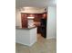 Kitchen with dark cabinets, granite counters, white appliances, and breakfast bar at 5725 Gatlin Ave # 315, Orlando, FL 32822