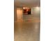 Spacious, empty living room, with tile floor and view of kitchen with breakfast bar at 5725 Gatlin Ave # 315, Orlando, FL 32822