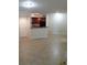 Open-concept living room and kitchen area with tile flooring and neutral walls at 5725 Gatlin Ave # 315, Orlando, FL 32822