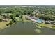 An aerial view of the community pool, tennis courts, lake, dock, playground, and neighborhood homes at 616 Woodridge Dr, Casselberry, FL 32730