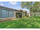 Property featuring a grass backyard and sliding glass doors for outdoor entertainment at 616 Woodridge Dr, Casselberry, FL 32730