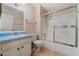 Traditional bathroom with blue vanity, ceramic tile floors, and a shower with glass door at 616 Woodridge Dr, Casselberry, FL 32730