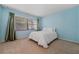 Cozy bedroom with a large window and comfortable carpet floors; ideal for relaxation at 616 Woodridge Dr, Casselberry, FL 32730