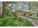 Charming home featuring a two-car garage and lush landscaping surrounded by mature trees at 616 Woodridge Dr, Casselberry, FL 32730