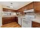 Bright kitchen featuring wood cabinets, laminate countertops, and a breakfast bar at 616 Woodridge Dr, Casselberry, FL 32730