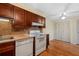 Cozy kitchen featuring wooden cabinets, tile backsplash, and modern white appliances at 616 Woodridge Dr, Casselberry, FL 32730