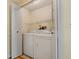 Convenient laundry room with washer, dryer, and wire rack shelving for easy organization at 616 Woodridge Dr, Casselberry, FL 32730