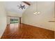 Spacious living room featuring gleaming wood floors, vaulted ceiling, and natural light at 616 Woodridge Dr, Casselberry, FL 32730