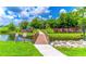 A bridge leads to the community playground with lush landscaping, providing a safe and fun environment at 616 Woodridge Dr, Casselberry, FL 32730