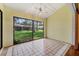 Bright sun room with tile flooring and large windows offering picturesque views at 616 Woodridge Dr, Casselberry, FL 32730
