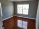 A bedroom featuring gleaming hardwood floors and a bright window at 6416 S Goldenrod Rd # 8A, Orlando, FL 32822
