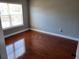 Cozy bedroom with hardwood floors and a window providing natural light at 6416 S Goldenrod Rd # 8A, Orlando, FL 32822