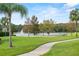 A lush park featuring a volleyball net, lake and green lawns at 6416 S Goldenrod Rd # 8A, Orlando, FL 32822