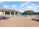 A community pool surrounded by lounge chairs and a spacious deck at 6416 S Goldenrod Rd # 8A, Orlando, FL 32822