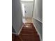 A staircase with wooden steps leading up to a white front door at 6416 S Goldenrod Rd # 8A, Orlando, FL 32822