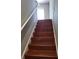 A staircase featuring wooden steps, leading to a bright doorway at 6416 S Goldenrod Rd # 8A, Orlando, FL 32822