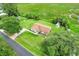 Aerial view of home with long driveway and lush green lawn, surrounded by fields and trees at 6720 Midland Drive, St Cloud, FL 34771