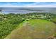 Wide aerial view of neighborhood with lake in the background at 6720 Midland Drive, St Cloud, FL 34771