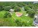 Aerial view of home with long driveway, lush green lawn, and surrounded by trees at 6720 Midland Drive, St Cloud, FL 34771