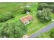 Aerial view of home with long driveway and lush green lawn at 6720 Midland Drive, St Cloud, FL 34771