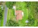 Aerial view of home with large yard and concrete driveway on a tree-lined street at 6720 Midland Drive, St Cloud, FL 34771