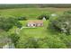 Aerial view of home with bright green lawn, surrounded by trees, and shed in backyard at 6720 Midland Drive, St Cloud, FL 34771