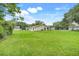 Large backyard with green lawn extending from back of home to shed at 6720 Midland Drive, St Cloud, FL 34771