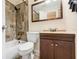 Cozy bathroom with tub-shower combo, tiled walls, updated vanity and sink at 6720 Midland Drive, St Cloud, FL 34771