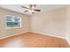 Bright bedroom features wood-look flooring, neutral walls, and a ceiling fan at 6720 Midland Drive, St Cloud, FL 34771
