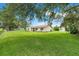 Single-story home with green shutters and a spacious yard at 6720 Midland Drive, St Cloud, FL 34771
