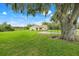 Home with large front yard with mature tree and a view of the back fields at 6720 Midland Drive, St Cloud, FL 34771